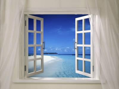 Window on a white wall opened to a blue sky